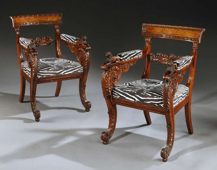 An outstanding pair of Regency period carved oak armchairs